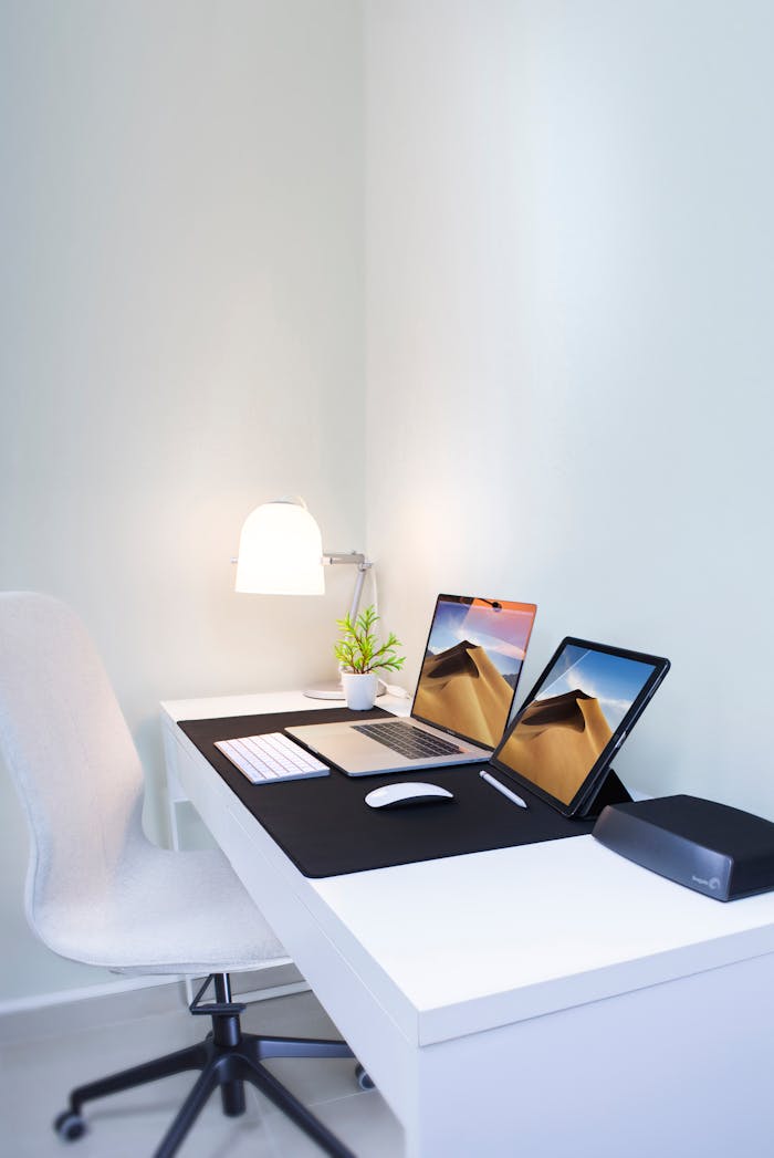 experience-img Stylish home office desk with dual screens and minimalist decor. Perfect for remote work and productivity.
