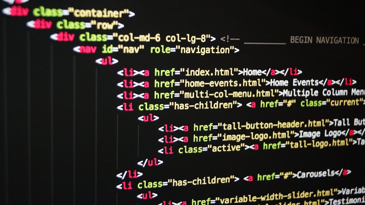 who-we-are-img Close-up of vibrant HTML code displayed on a computer screen, showcasing web development and programming.